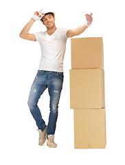 Image showing handsome builder with big boxes