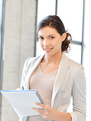 Image showing happy woman with big notepad