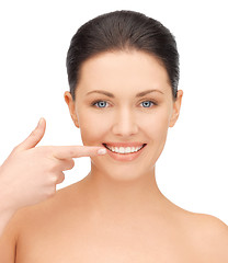 Image showing beautiful woman pointing to teeth