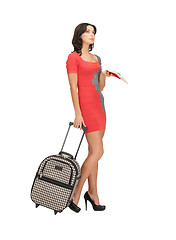 Image showing pensive woman with suitcase and book