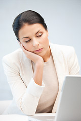 Image showing pensive woman with laptop computer