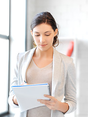 Image showing happy woman with big notepad