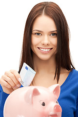 Image showing lovely woman with piggy bank and money