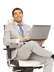 Image showing young businessman sitting in chair with laptop