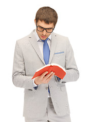 Image showing calm and serious man with book