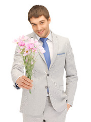 Image showing handsome man with flowers in hand