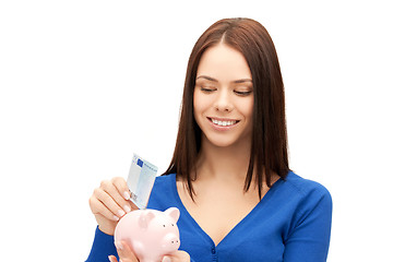 Image showing lovely woman with piggy bank and money