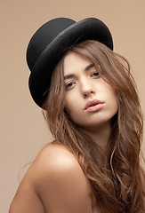 Image showing beautiful topless woman in bowler hat