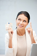 Image showing happy woman with laptop computer and money