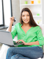 Image showing happy woman with laptop computer and credit card