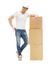 Image showing handsome builder with big boxes