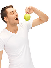 Image showing man in white shirt with green apple