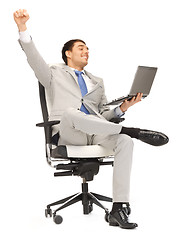 Image showing young businessman sitting in chair with laptop