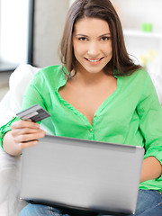 Image showing happy woman with laptop computer and credit card