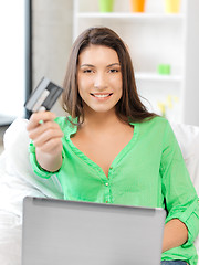 Image showing happy woman with laptop computer and credit card