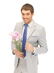 Image showing handsome man with flowers in hand