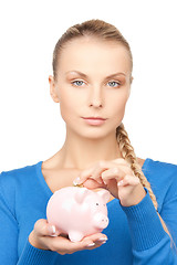 Image showing lovely woman with piggy bank and money