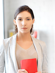 Image showing calm and serious woman with book