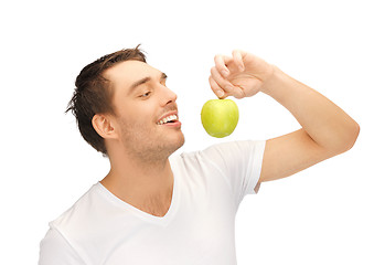 Image showing man in white shirt with green apple