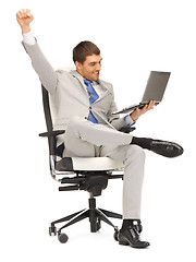 Image showing young businessman sitting in chair with laptop