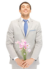 Image showing handsome man with flowers in hand