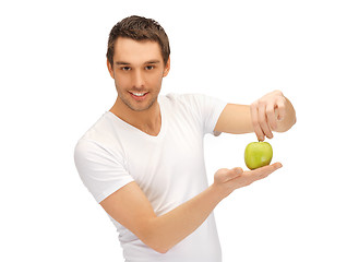 Image showing man in white shirt with green apple