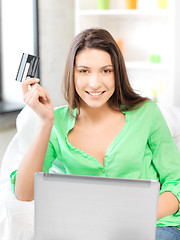 Image showing happy woman with laptop computer and credit card