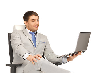 Image showing young businessman sitting in chair with laptop