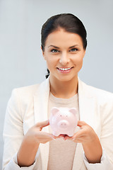 Image showing lovely woman with piggy bank