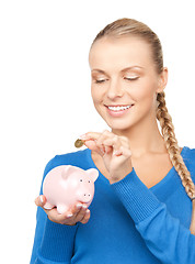 Image showing lovely woman with piggy bank and money