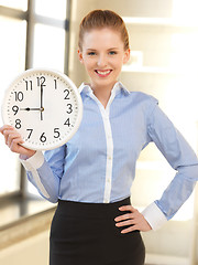 Image showing attractive businesswoman with clock