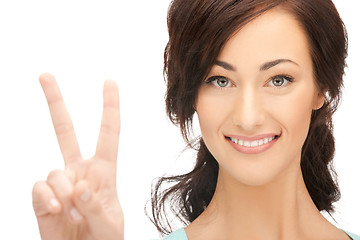 Image showing young woman showing victory sign