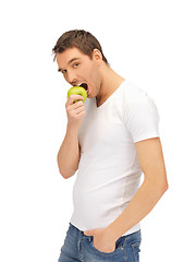 Image showing man in white shirt with green apple