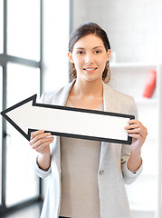 Image showing businesswoman with direction arrow sign