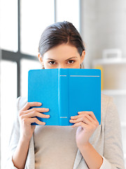 Image showing calm and serious woman with book