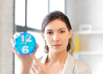 Image showing businesswoman with clock