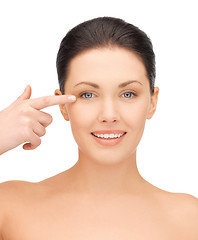 Image showing beautiful woman pointing to eye