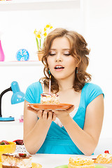 Image showing lovely housewife with cake and candle