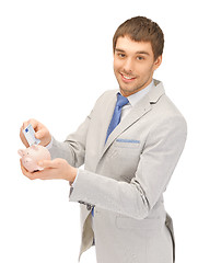 Image showing man with piggy bank and money