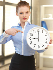 Image showing attractive businesswoman with clock