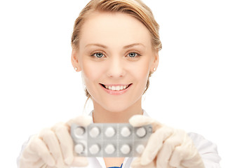 Image showing attractive female doctor with pills