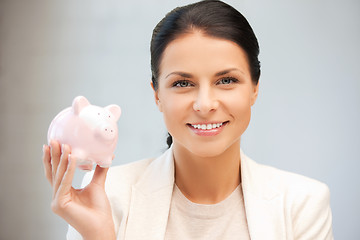 Image showing lovely woman with piggy bank