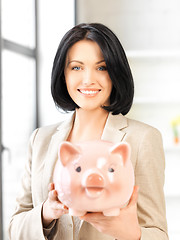 Image showing lovely woman with piggy bank