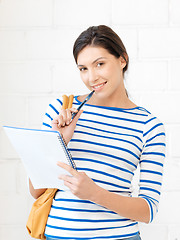 Image showing happy woman with big notepad