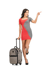 Image showing woman with suitcase pointing her finger