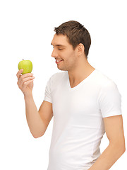 Image showing man in white shirt with green apple