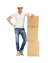Image showing handsome builder with big boxes