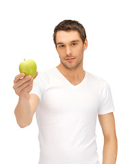 Image showing man in white shirt with green apple