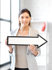 Image showing businesswoman with direction arrow sign