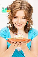 Image showing lovely housewife with cake and candle